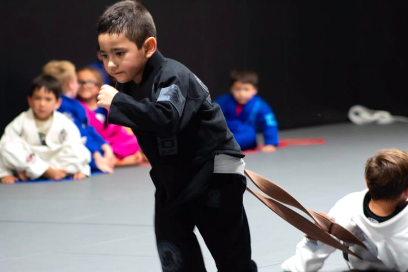 Kids playing a belt tug game