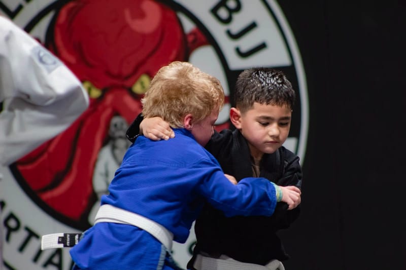 Two boys grip fighting from standing