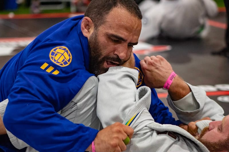 A competitor fighting for a lapel grip in a match